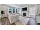 Bright and modern living room with a fireplace, hardwood floors, and large windows at 13222 Fiore Pl, Huntersville, NC 28078
