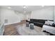 Spacious living room includes a comfortable sofa, modern rug, and plenty of room to entertain guests at 13222 Fiore Pl, Huntersville, NC 28078