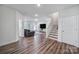 Bright living room showcasing wood floors, a staircase, and an open layout, perfect for modern living at 13222 Fiore Pl, Huntersville, NC 28078