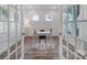A bright, airy office with neutral colors, a decorative rug, and French doors at 13222 Fiore Pl, Huntersville, NC 28078