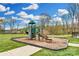 A community playground with slides, climbing structures, and green space provides outdoor fun for children at 13222 Fiore Pl, Huntersville, NC 28078