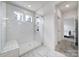 All-white tiled shower with glass doors and a built in bench at 13222 Fiore Pl, Huntersville, NC 28078