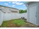 Small backyard featuring a white fence and access door in a townhome community at 13358 Calloway Glen Dr, Charlotte, NC 28273