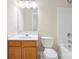 Bathroom with wood vanity, framed mirror, toilet and tub/shower combo at 13358 Calloway Glen Dr, Charlotte, NC 28273