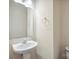 Well-lit half bathroom features a pedestal sink, decorative mirror and modern fixtures at 13358 Calloway Glen Dr, Charlotte, NC 28273