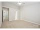 Spacious bedroom with neutral tones, carpet flooring, and a ceiling fan at 13358 Calloway Glen Dr, Charlotte, NC 28273