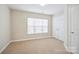 Bright bedroom with carpet flooring, closet, and a large window offering ample natural light at 13358 Calloway Glen Dr, Charlotte, NC 28273