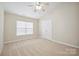 Neutral bedroom with carpet flooring, double closet and window at 13358 Calloway Glen Dr, Charlotte, NC 28273
