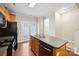 Bright kitchen with hardwood floors, island sink, stainless steel appliances, and access to the backyard at 13358 Calloway Glen Dr, Charlotte, NC 28273