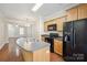Stylish kitchen featuring a center island, black appliances, and an open layout for easy entertaining at 13358 Calloway Glen Dr, Charlotte, NC 28273