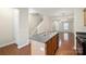 Functional kitchen with a central island, stainless steel sink, and easy access to the living areas at 13358 Calloway Glen Dr, Charlotte, NC 28273