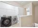 Convenient laundry room with modern appliances and built-in shelving for storage at 13358 Calloway Glen Dr, Charlotte, NC 28273