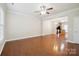 Spacious living room with hardwood floors, a ceiling fan, and an open layout into the kitchen at 13358 Calloway Glen Dr, Charlotte, NC 28273
