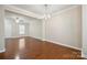 Expansive living room with hardwood floors, neutral tones, seamlessly connecting to the dining area at 13358 Calloway Glen Dr, Charlotte, NC 28273