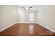 Inviting living room featuring hardwood floors, ample natural light, and a front entry door at 13358 Calloway Glen Dr, Charlotte, NC 28273