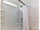 Bright bathroom featuring a shower-tub combination with white tile surround and built-in shelving at 134 Kerri Dawn Ln # 117, Locust, NC 28097