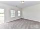 Bright bedroom featuring neutral carpet, white walls, and a door leading to the outside at 134 Kerri Dawn Ln # 117, Locust, NC 28097
