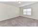Clean, carpeted bedroom with large window, providing natural light and comfortable living space at 134 Kerri Dawn Ln # 117, Locust, NC 28097