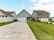 Charming home with blue siding, a two-car garage, and well-manicured lawn and driveway at 134 Kerri Dawn Ln # 117, Locust, NC 28097