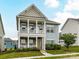 Charming two-story home featuring a double porch, stone accents, and manicured landscaping at 134 Kerri Dawn Ln # 117, Locust, NC 28097