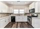Bright kitchen features white cabinets, stainless steel appliances and a stone backsplash at 134 Kerri Dawn Ln # 117, Locust, NC 28097