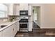 Contemporary kitchen features white cabinets and stainless steel appliances at 134 Kerri Dawn Ln # 117, Locust, NC 28097