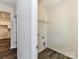 Functional laundry area with hardwood floors and a wire shelf for storage above the washer and dryer hookups at 134 Kerri Dawn Ln # 117, Locust, NC 28097