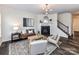 Inviting living room with dark wood floors, a fireplace, and elegant chandelier at 134 Kerri Dawn Ln # 117, Locust, NC 28097