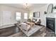 Inviting living room with dark wood floors, a fireplace, and elegant chandelier at 134 Kerri Dawn Ln # 117, Locust, NC 28097