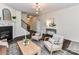 Inviting living room with dark wood floors, a fireplace, and elegant chandelier at 134 Kerri Dawn Ln # 117, Locust, NC 28097