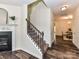 Inviting foyer showcasing a carpeted staircase with wooden handrail and an adjacent dining area at 134 Kerri Dawn Ln # 117, Locust, NC 28097