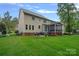 Spacious backyard with a screened-in porch and a brick patio with seating, perfect for outdoor entertaining at 1402 Coachman Dr, Waxhaw, NC 28173