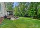 Lush backyard featuring a brick patio with outdoor seating and a screened-in porch, perfect for relaxing at 1402 Coachman Dr, Waxhaw, NC 28173