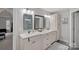 Luxurious bathroom with double vanity, modern mirrors, and tiled floors at 1402 Coachman Dr, Waxhaw, NC 28173