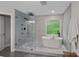 Modern bathroom with a glass shower, freestanding tub, and contemporary fixtures at 1402 Coachman Dr, Waxhaw, NC 28173