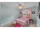 Charming bedroom with pink accents, a ceiling fan, and a comfortable bed with decorative pillows and a quilt at 1402 Coachman Dr, Waxhaw, NC 28173