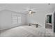 Large bedroom with neutral carpet, a window, and a simple bench at 1402 Coachman Dr, Waxhaw, NC 28173