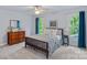 Cozy bedroom with a wooden-framed bed, a ceiling fan, and two large windows offering natural light at 1402 Coachman Dr, Waxhaw, NC 28173