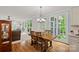 Inviting breakfast nook featuring a wooden table, four chairs and large sunny windows at 1402 Coachman Dr, Waxhaw, NC 28173