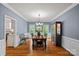 Dining room with hardwood floors, stylish chandelier, and views to the backyard at 1402 Coachman Dr, Waxhaw, NC 28173