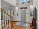 Grand foyer with soaring ceilings, hardwood floors, and a stylish blue patterned rug at 1402 Coachman Dr, Waxhaw, NC 28173