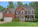 Beautiful two-story brick home with a manicured lawn and welcoming front porch at 1402 Coachman Dr, Waxhaw, NC 28173