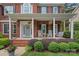 Inviting front porch with rocking chairs, swing, and decorative plants creating a cozy outdoor space at 1402 Coachman Dr, Waxhaw, NC 28173
