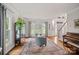 Inviting living room featuring hardwood floors, a piano, and views of the foyer at 1402 Coachman Dr, Waxhaw, NC 28173