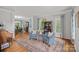 Open-concept living room with hardwood floors, seating and views to dining room at 1402 Coachman Dr, Waxhaw, NC 28173