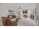 Bright living room with a cozy fireplace, hardwood floors, and a comfortable leather sofa at 1402 Coachman Dr, Waxhaw, NC 28173
