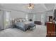 Spacious main bedroom with trey ceilings, carpet, and multiple windows at 1402 Coachman Dr, Waxhaw, NC 28173