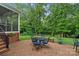 Brick patio featuring outdoor seating with a screened-in porch and lush greenery at 1402 Coachman Dr, Waxhaw, NC 28173