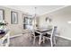 Cozy dining room with a wooden table, six chairs, and large window with natural light at 18631 Harborside Dr, Cornelius, NC 28031
