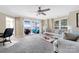 Spacious living room featuring sliding glass doors to a balcony and comfortable seating at 18631 Harborside Dr, Cornelius, NC 28031
